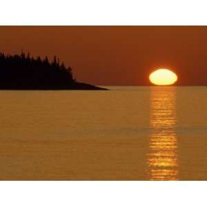 Spring Sunrise Silhouettes Edwards Island and Reflects Light on Lake 