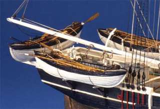 Four laser cut wooden whaleboats plus deck furnishings, including the 
