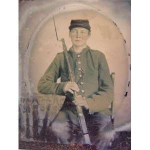   young soldier in Union uniform with bayoneted musket