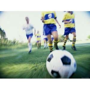Low Angle View of a Girls Soccer Team Playing Soccer on a Field 