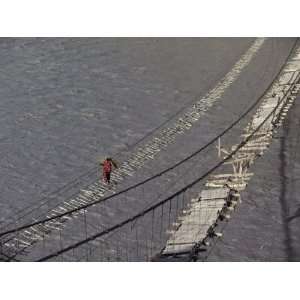  A Hunzukut Woman Crosses a Footbridge over the Hunza River 
